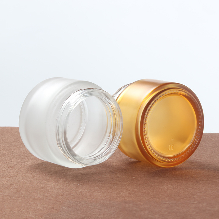 100g brown frosted glass cream jar cosmetic film container with gold black silver plastic lid