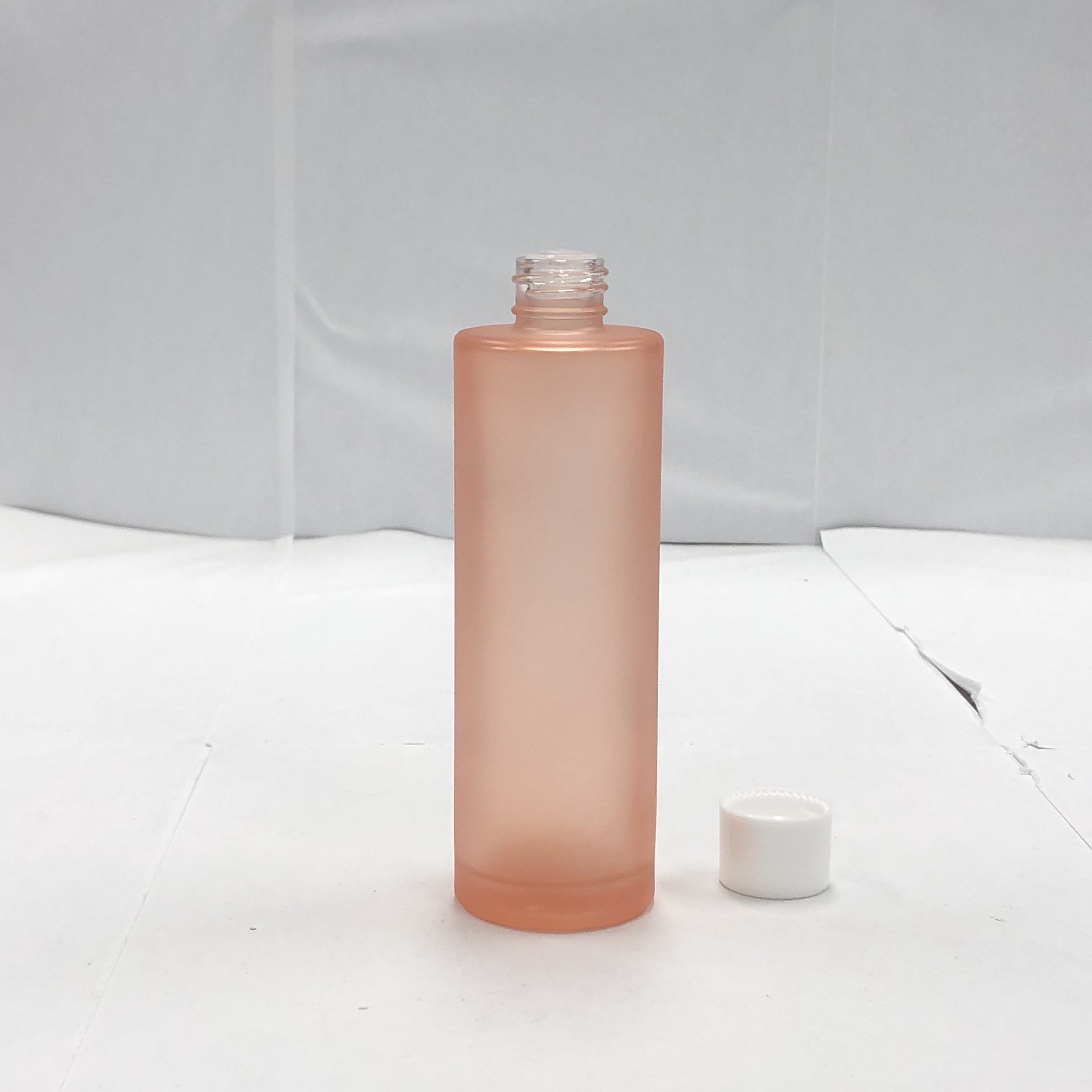 100ml orange color cosmetic round glass bottle with inner reducer and plastic screw cap