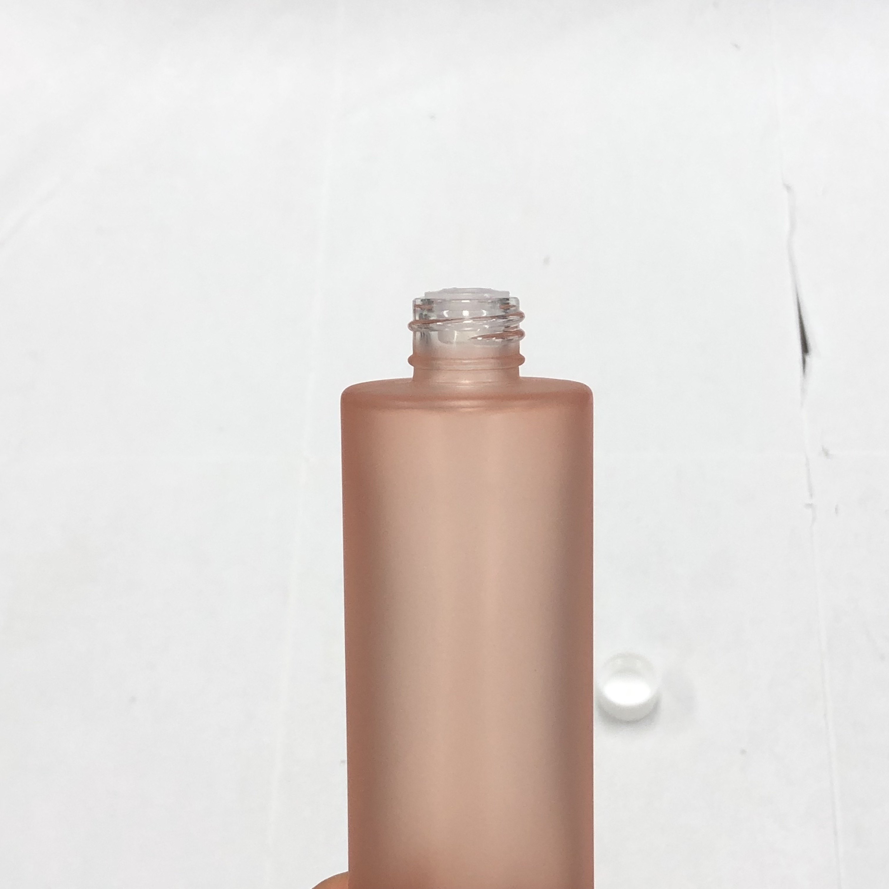 100ml orange color cosmetic round glass bottle with inner reducer and plastic screw cap