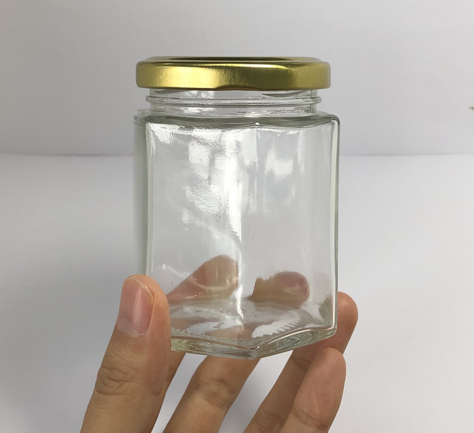180ml clear hexagonal glass jar with golden metal screw cap
