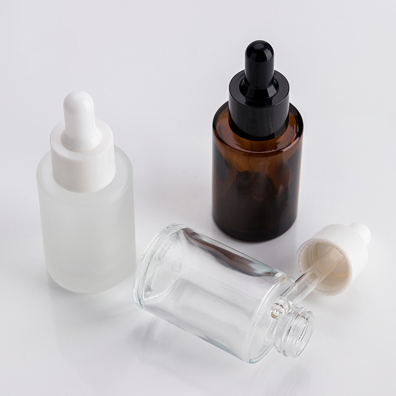 1oz flat shoulder clear glass dropper bottle with black lid for cosmetic packaging