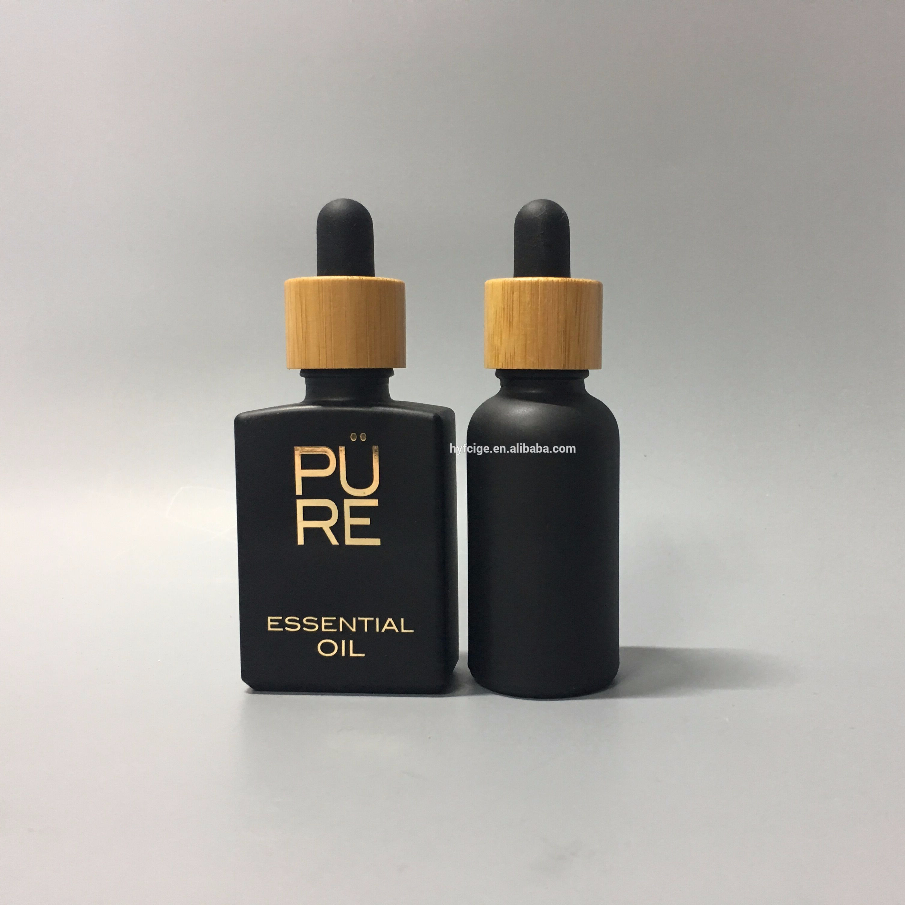 1oz matte black CBD oil glass bottle with bamboo cap and hot stamping