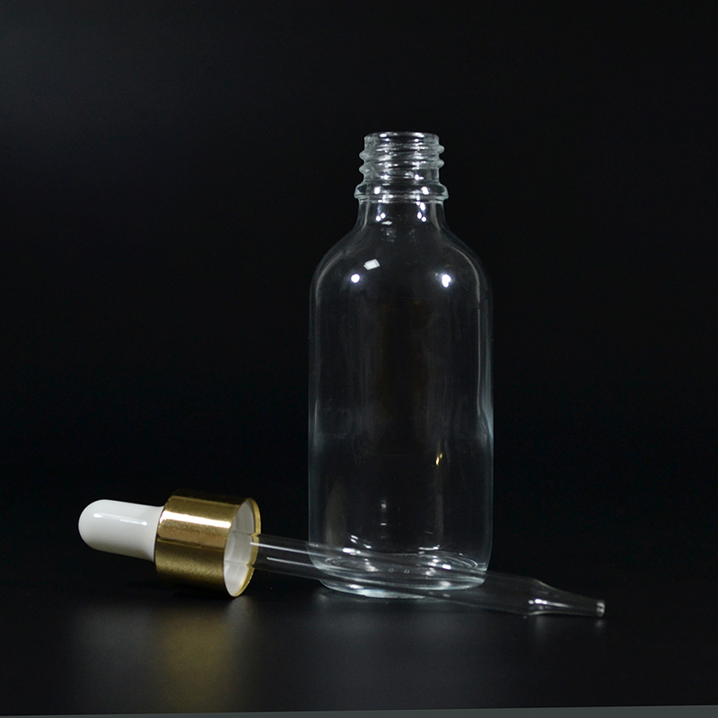 2 oz Clear Glass Boston Round Bottle with Gold Metal and Glass Dropper