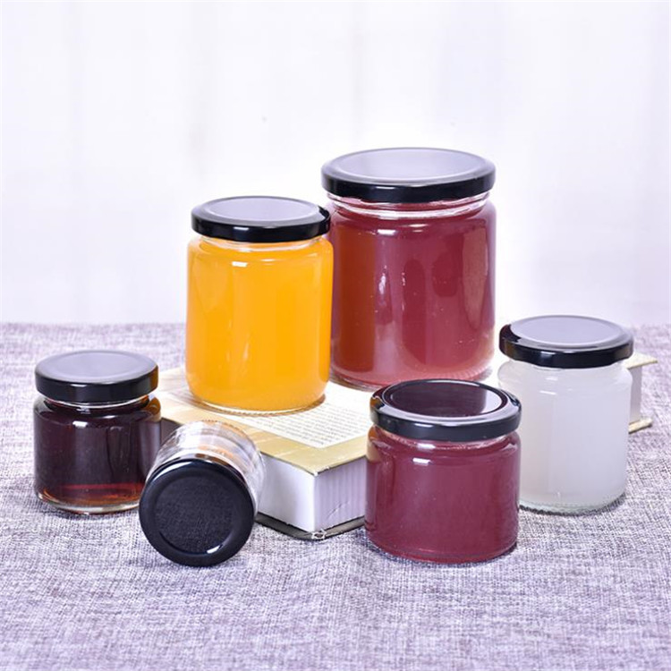 250ml wholesale round glass bottles food glass jars with black tin metal lid for honey candy packaging