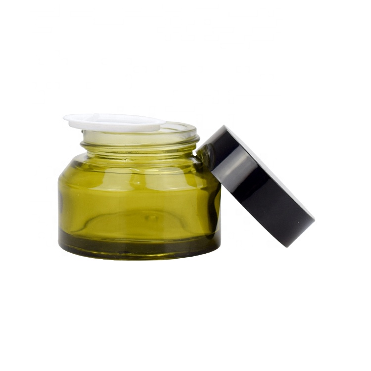 30g 50g wholesale fancy slant shoulder clear green glass cosmetic face eye cream jar for skin care with black plastic screw lid