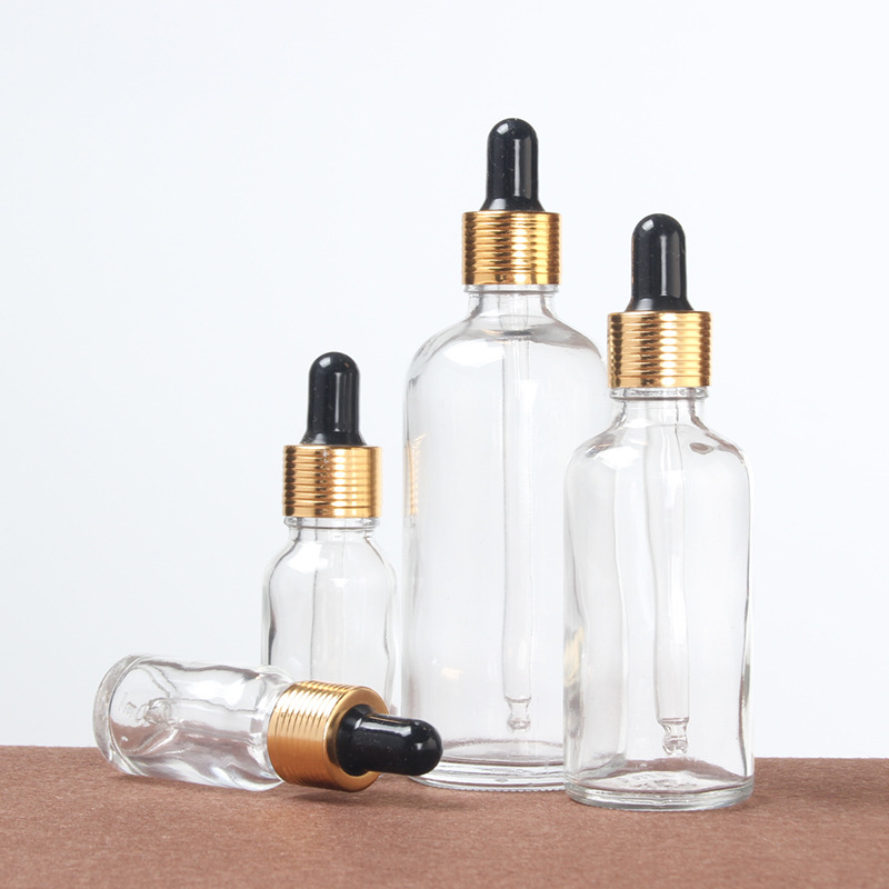 30ml 100ml transparent glass bottle essential oil bottle with stopper gold cap for cosmetic packing