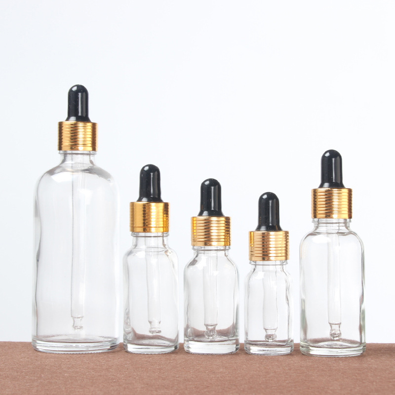 30ml 100ml transparent glass bottle essential oil bottle with stopper gold cap for cosmetic packing