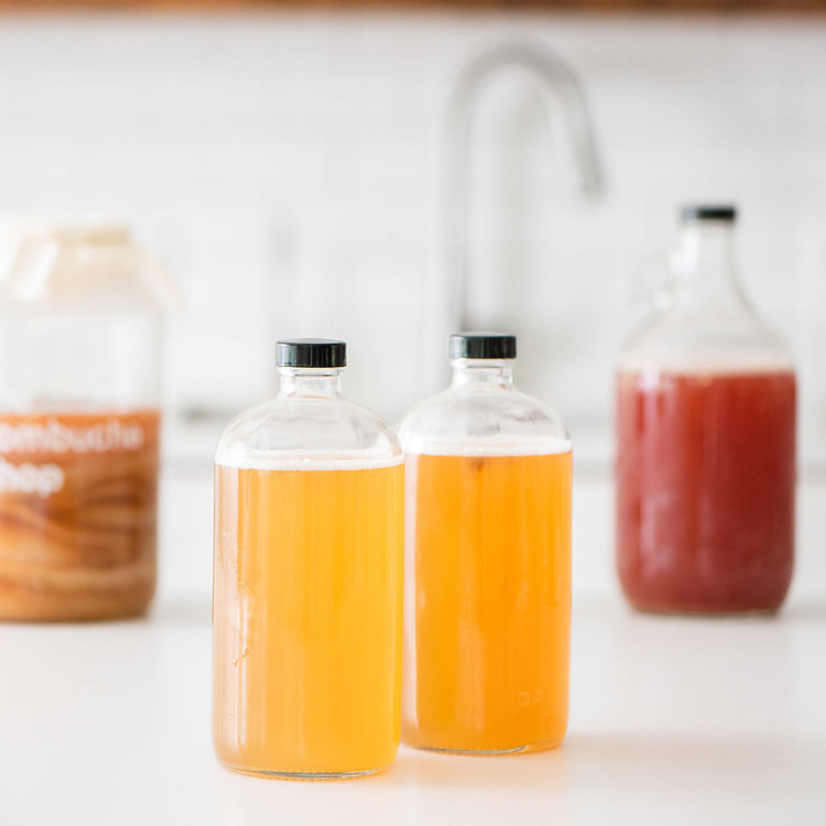 32 oz. Boston Round Clear Glass Bottle for Kombucha Mineral Water with Polyethylene Cone Caps