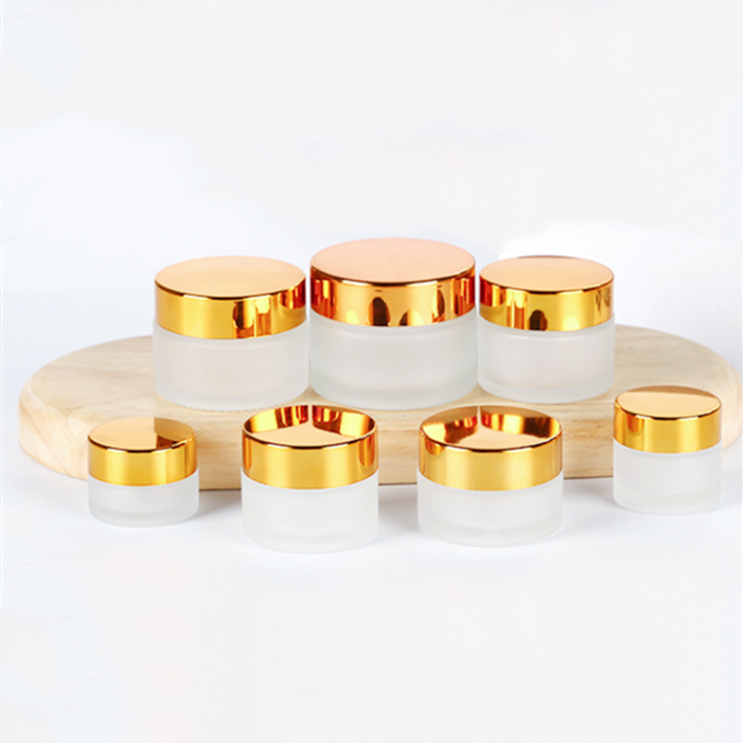 5g to 100g frosted round glass jar with golden black sliver plastic cap for lotions eye creams
