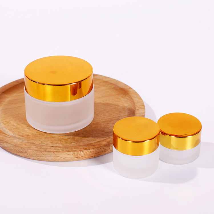 5g to 100g frosted round glass jar with golden black sliver plastic cap for lotions eye creams