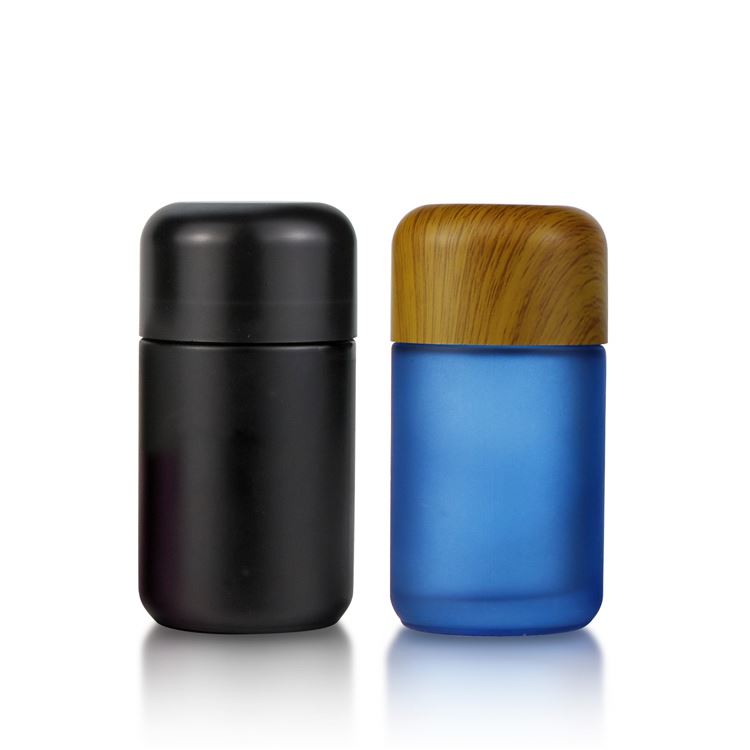 A variety of capacity bamboo cbd flower packaging with child proof cap 1oz 50ml frosted blue glass jar with child resistant cap