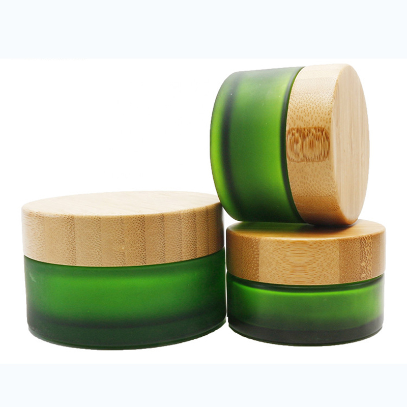 Bamboo containers for cosmetics glass jar 50g clear green glass wooden jar matte frosted green glass jar with engraved logo