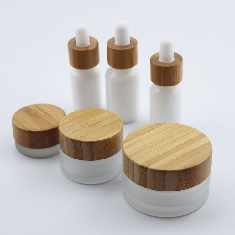 Beautiful elegant cosmetic glass bottle glass jar with bamboo cap for packaging