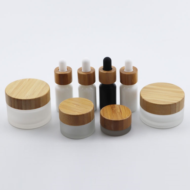 Beautiful elegant cosmetic glass bottle glass jar with bamboo cap for packaging
