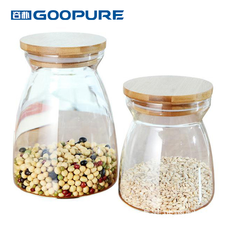 Beautifully shaped transparent glass sealed storage jar with bamboo lid