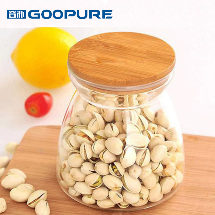 Beautifully shaped transparent glass sealed storage jar with bamboo lid