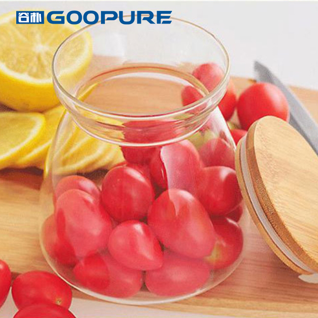 Beautifully shaped transparent glass sealed storage jar with bamboo lid