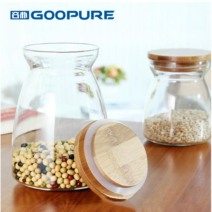 Beautifully shaped transparent glass sealed storage jar with bamboo lid