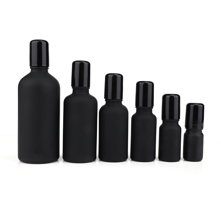 Black frosted glass roll on bottle with metal roller filling essential oil