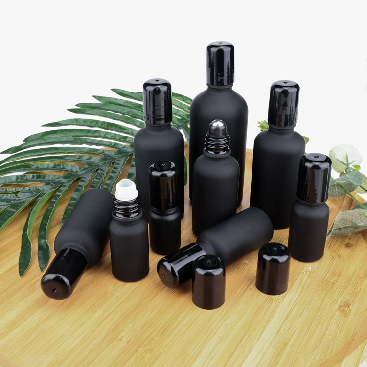 Black glass bottle with mental roll on for cosmetic packaging