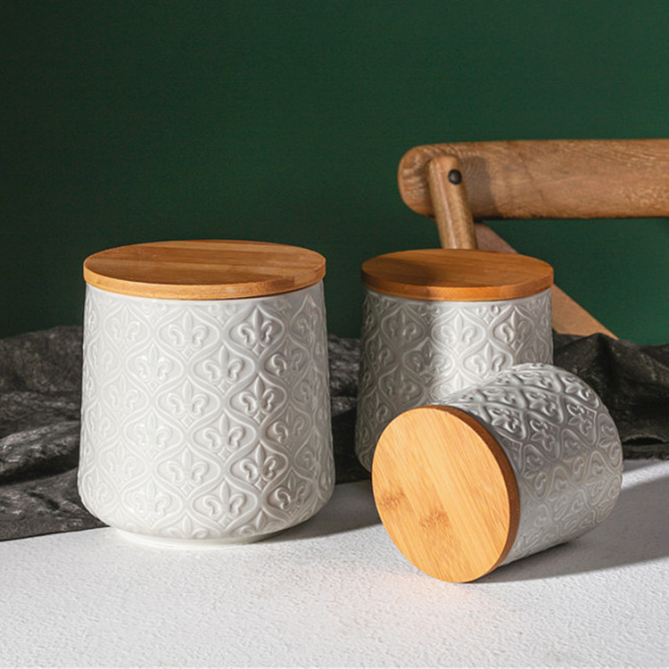 Bulk manufacture embossed white cylinder food snack canister ceramic sugar tea coffee storage jars with wood lid