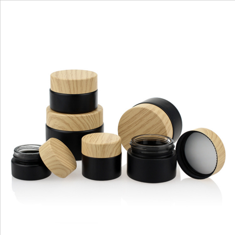Cheap price frosted black eye cream glass cosmetic bottle with imitation wood cap