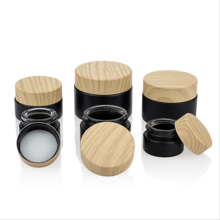 Cheap price frosted black eye cream glass cosmetic bottle with imitation wood cap
