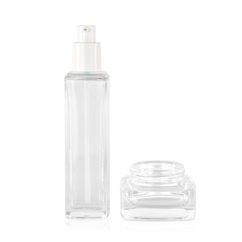 Clear cosmetic skincare glass lotion pump bottle and cream jar with gold screw top