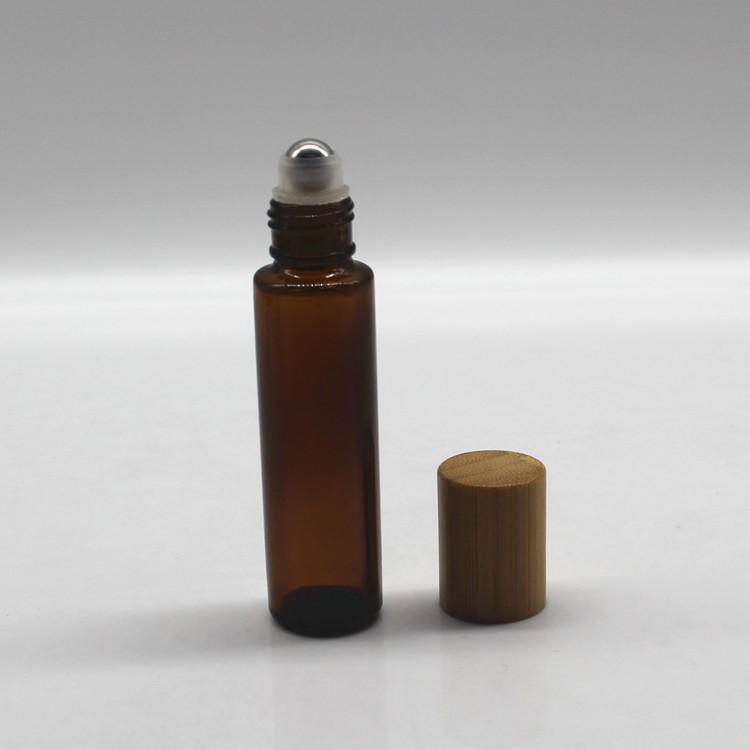 Clear glass roller perfume bottle with bamboo cap and metal roller