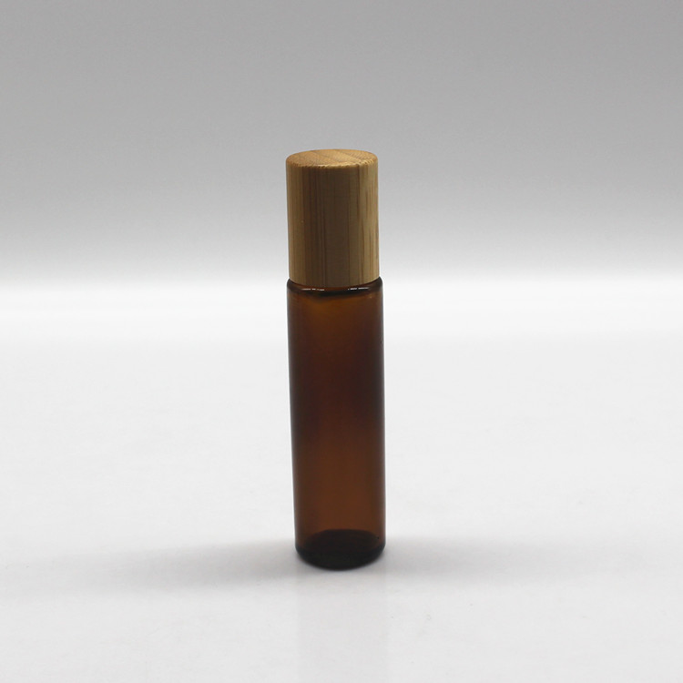 Clear glass roller perfume bottle with bamboo cap and metal roller