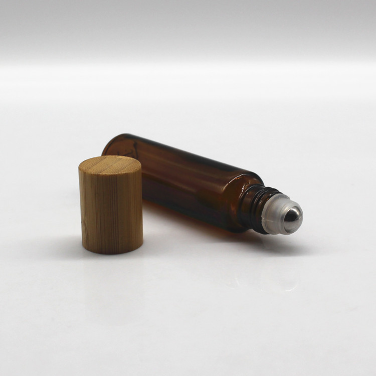Clear glass roller perfume bottle with bamboo cap and metal roller