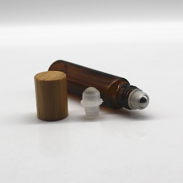 Clear glass roller perfume bottle with bamboo cap and metal roller
