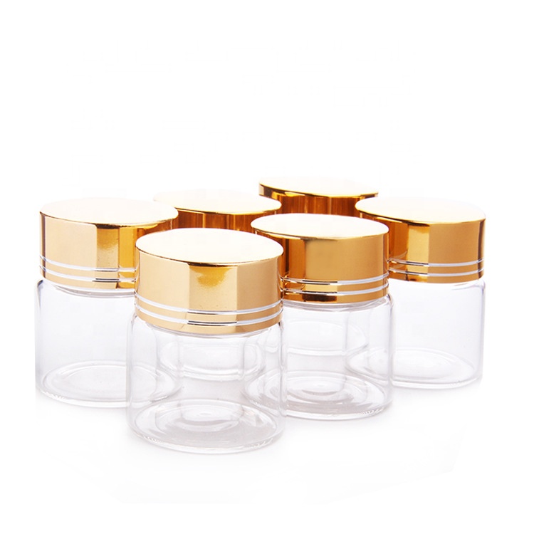 Clear glass saffron capsule pill bottle with aluminum cover