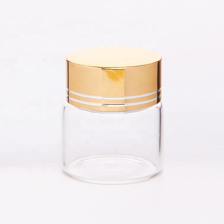 Clear glass saffron capsule pill bottle with aluminum cover
