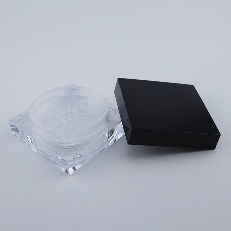 Clear plastic square cream jar with black lid