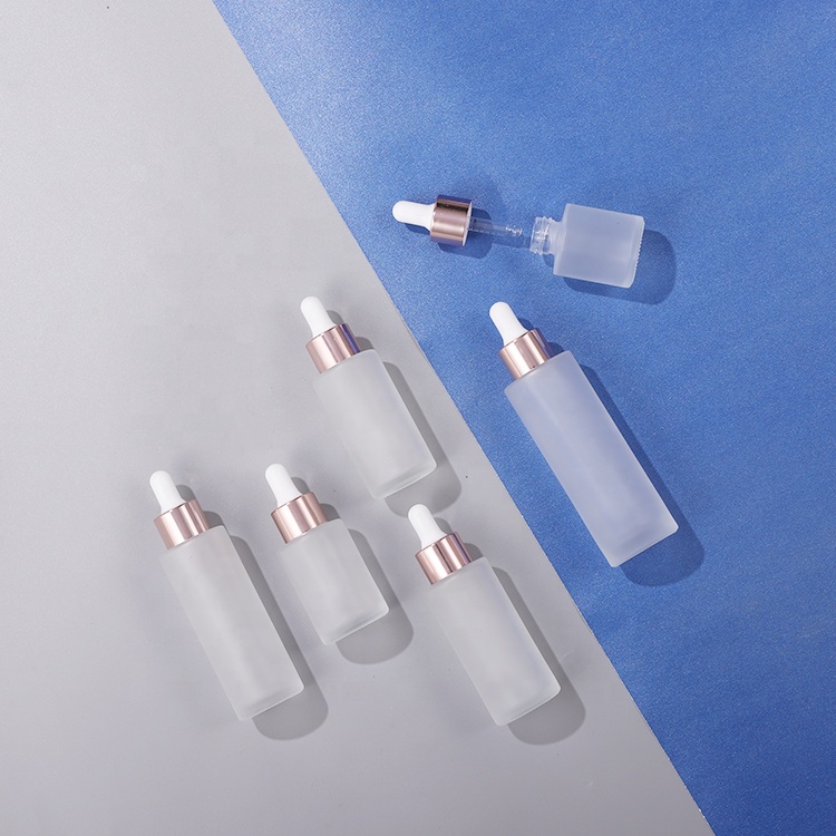 Cosmetic 30ml 40ml 50ml clear frosted flat shoulder essential oil glass bottle with rose gold dropper lid