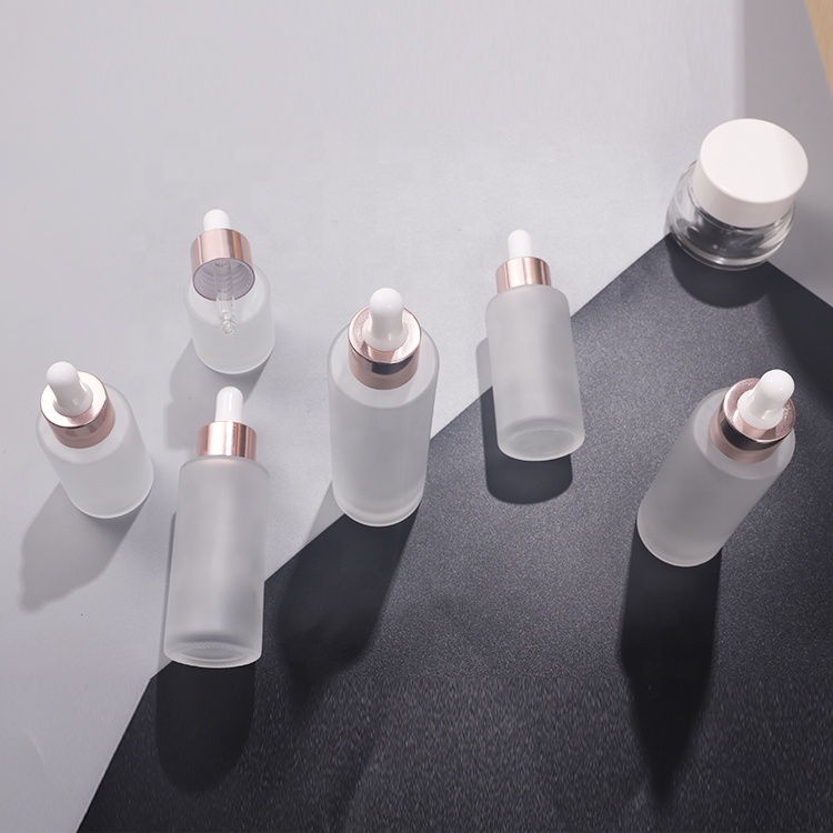 Cosmetic 30ml 40ml 50ml clear frosted flat shoulder essential oil glass bottle with rose gold dropper lid