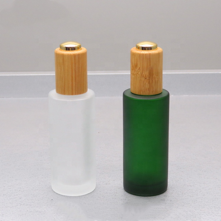 Cosmetic oil bottle green frosted 1oz 30ml flat shoulder glass bottle with bamboo pump cap