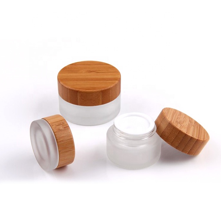 Cosmetic packaging 15g 30g 50g 100g 1 oz clear frosted glass jar with logo printing and gold or silver lids bamboo lids