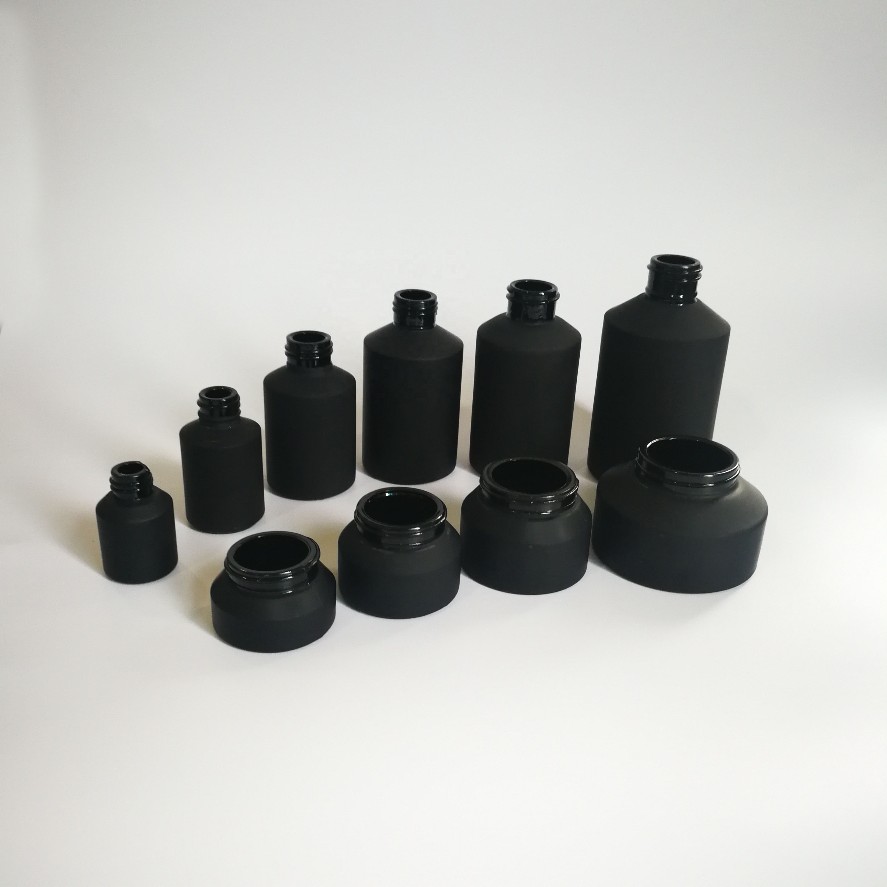 Cosmetic packaging slant shoulder matte black skin care set black glass bottle with bamboo dropper and bamboo cap jar