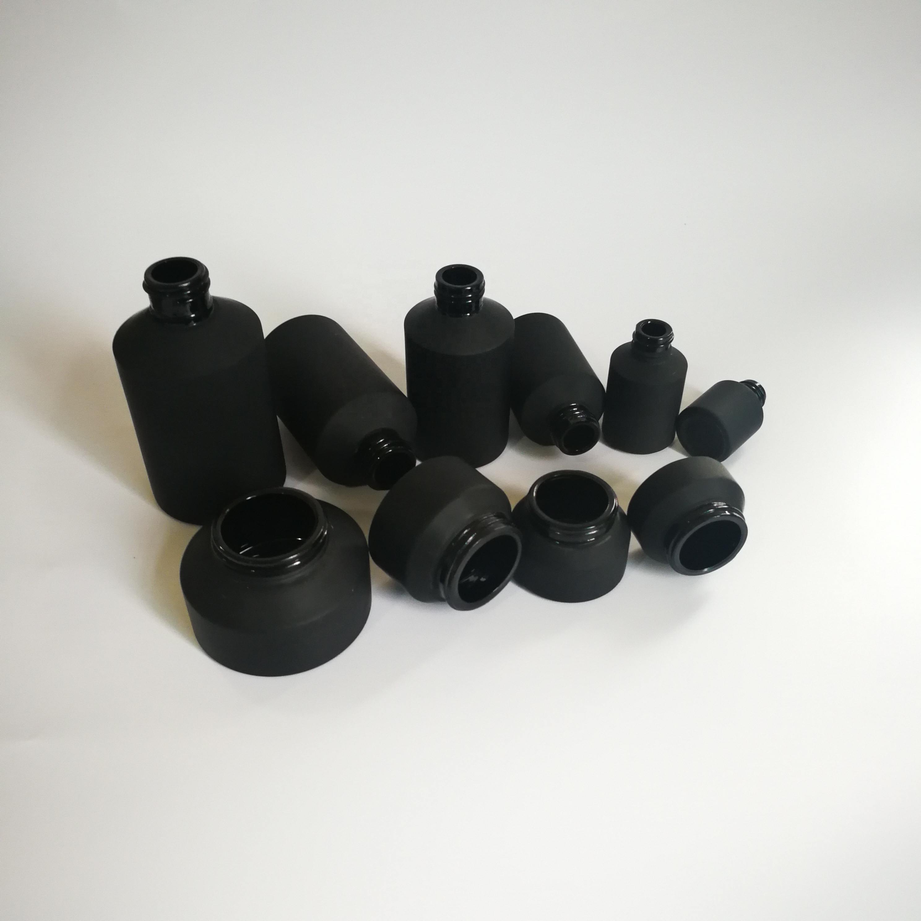 Cosmetic packaging slant shoulder matte black skin care set black glass bottle with bamboo dropper and bamboo cap jar