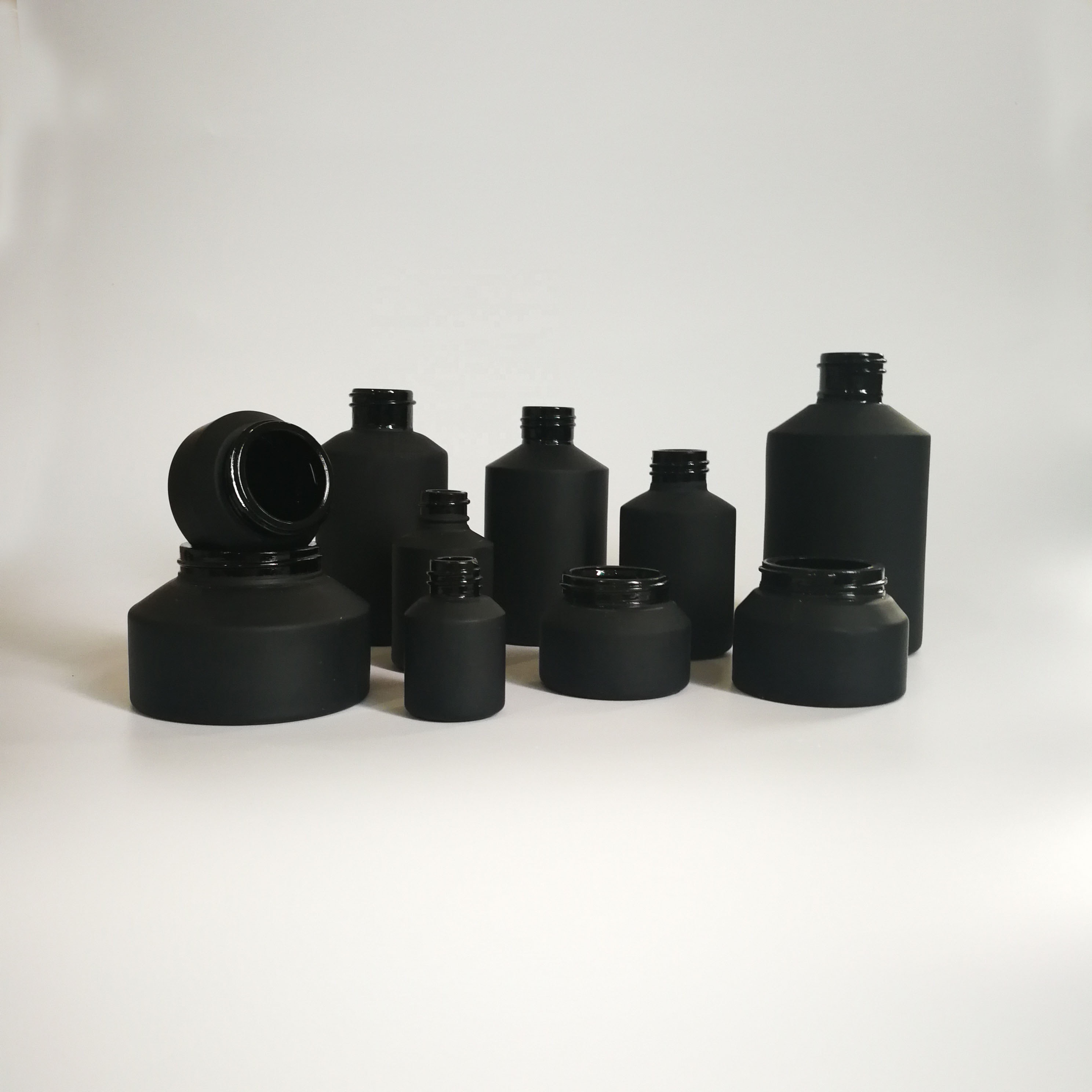 Cosmetic packaging slant shoulder matte black skin care set black glass bottle with bamboo dropper and bamboo cap jar