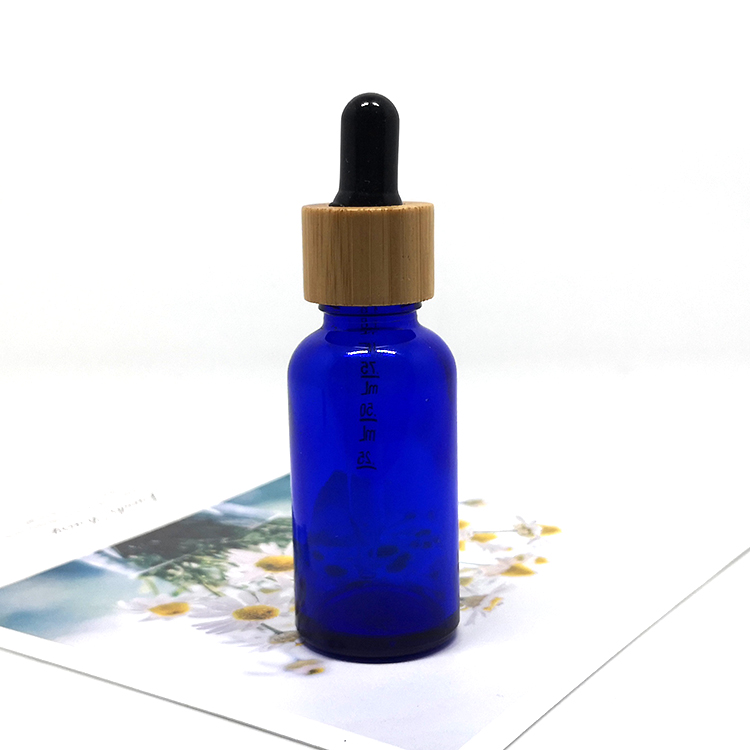 Cosmetic skin care oil packaging 30ml frosted cobalt blue glass bottles with bamboo dropper caps