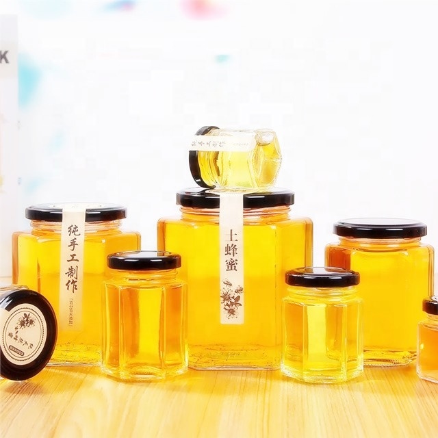 Custom 45ml 85ml 100ml 180ml 280ml 380ml 500ml 730ml food grade hexagonal glass honey jar with metal lid