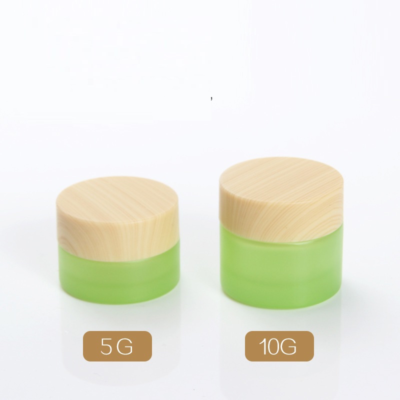 Custom logo 5g and 10g green and pearl white glass jar cosmetic package container with black white wood grain cap in good price