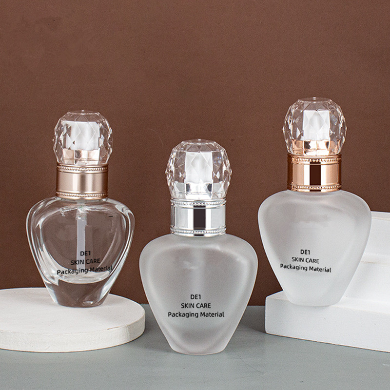 Custom logo luxury 30ml unique shape glass pump bottle cosmetic package for liquid foundation with diamond cap in good price
