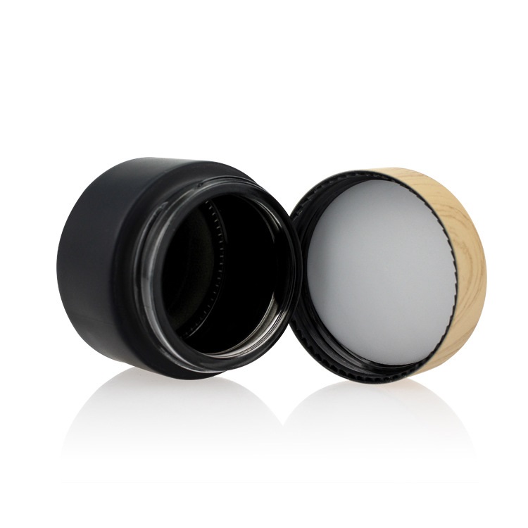 Custom logo small package 10g 15g 20g 30g 50g 60g black glass jar with wood grain cap for cosmetic facial essence cream