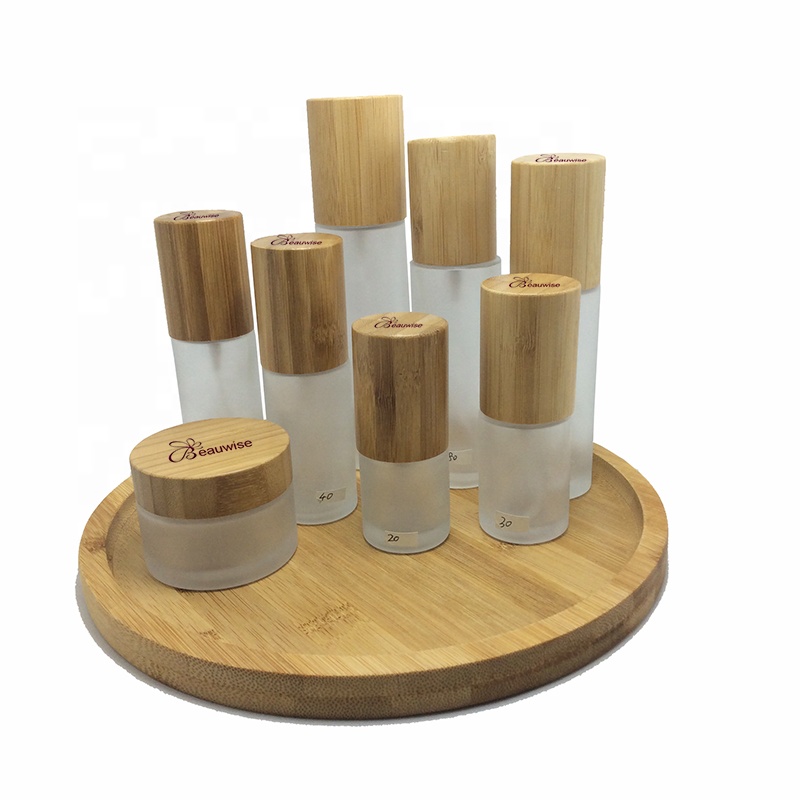 Custom made environment-friendly wooden bamboo glass cosmetic bottles, including tree box packaging, carving customer trademarks