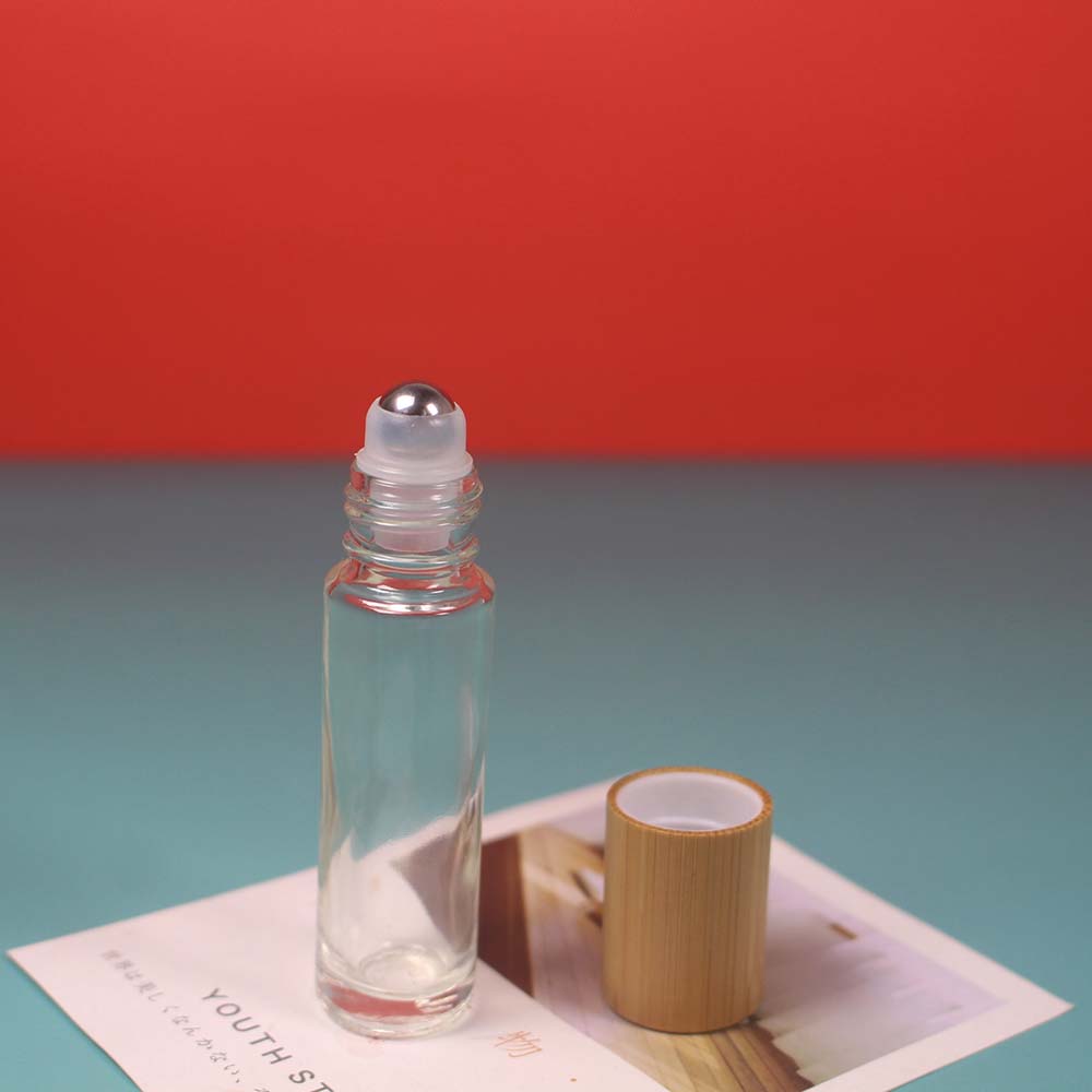 Empty bamboo cap glass roll on bottle with stainless roller ball