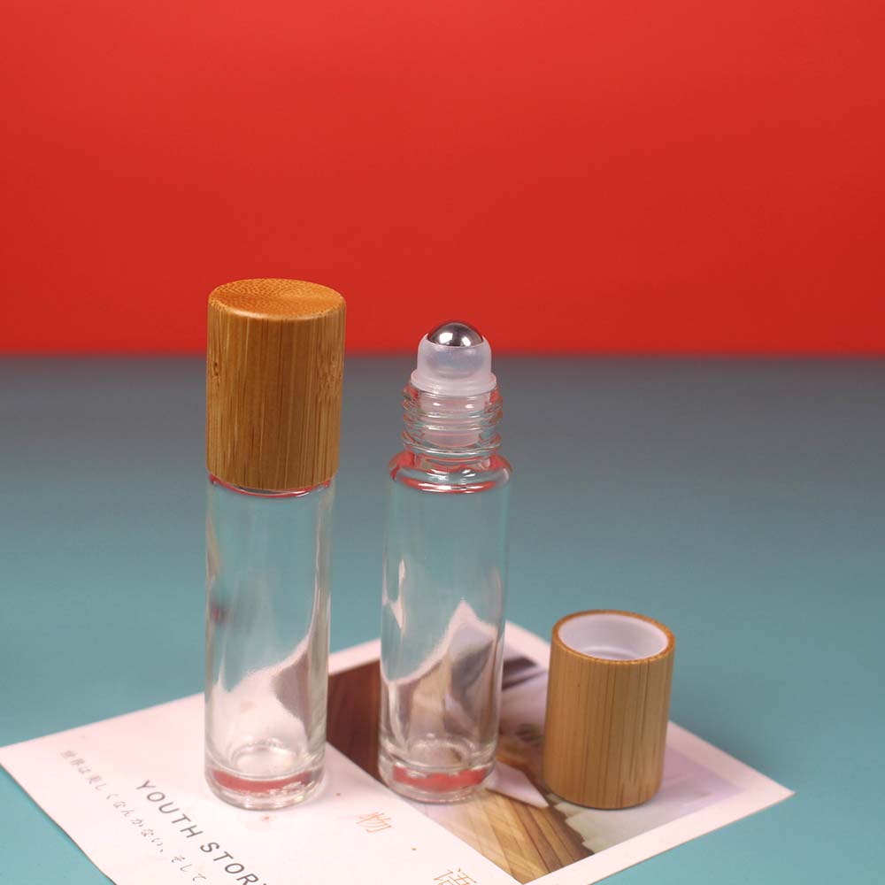 Empty bamboo cap glass roll on bottle with stainless roller ball